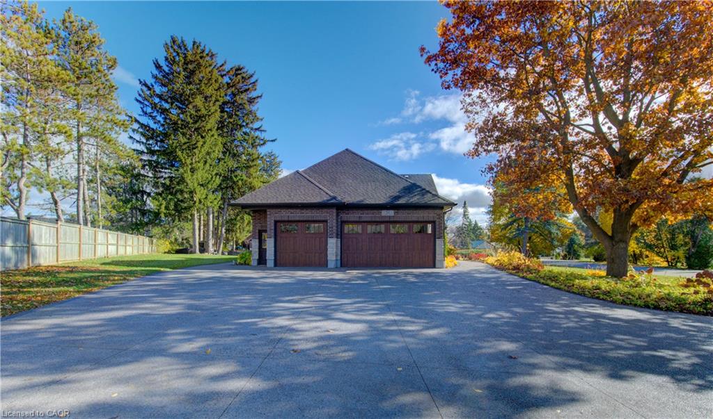 Triple bay garage with manicured driveway