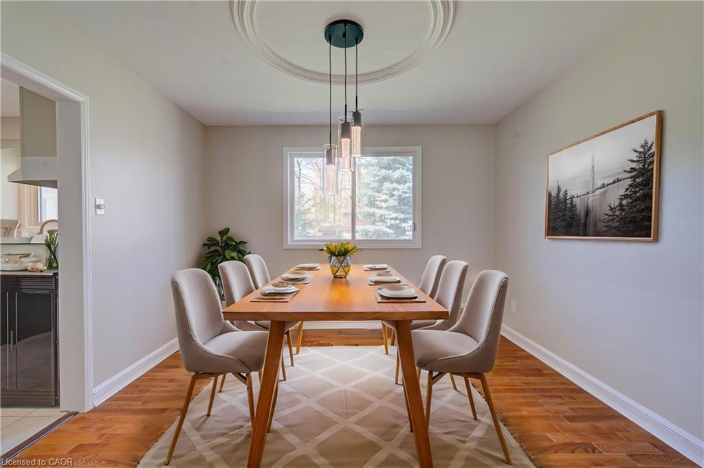 Staged dining room with mid century table and pendant lighting