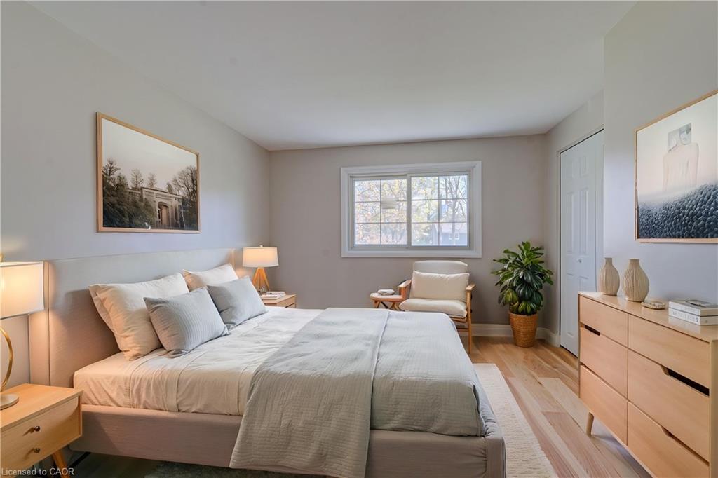 Primary bedroom with natural light and warm wood accents